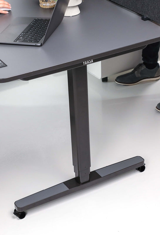 Höhenverstellbarer Yaasa Schreibtisch mit Schreibtisch-Rollen.